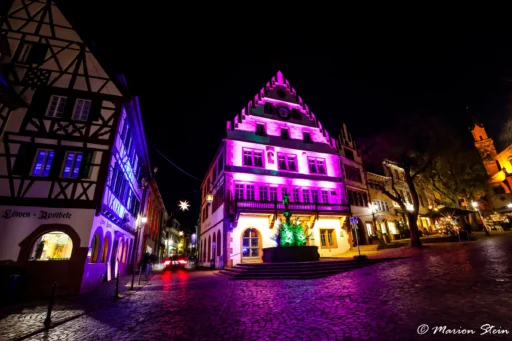 ein lila angeleuchtetes haus im dunkeln